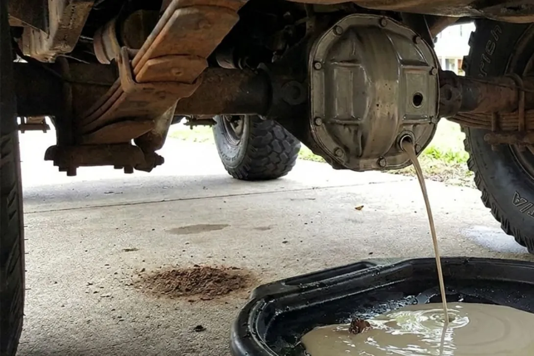 Grey fluid draining from rear jeep CJ diff